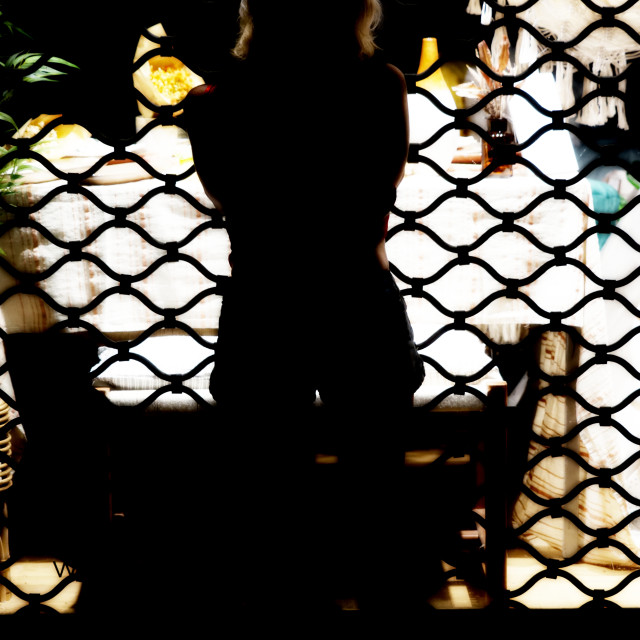 "A woman in front of a vitrine" by Amit Mendelsohn - £50.00 "A woman in front of a vitrine" stock image