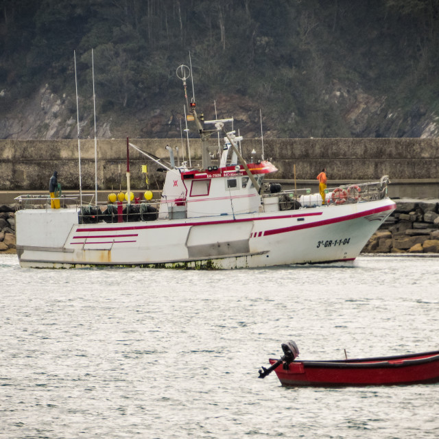 "Fishing boat coming in to harbour." stock image