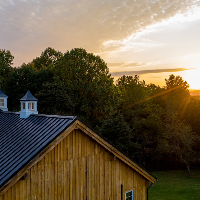 "Sun setting over the Old Oak Barn" stock image