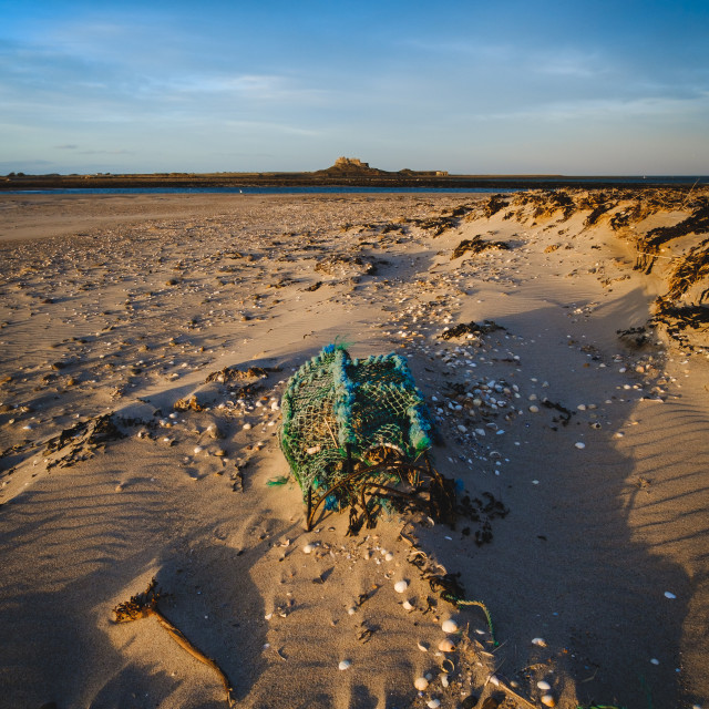 "Lobster Crate at Ross Sands with Lindisfarne in the background" stock image