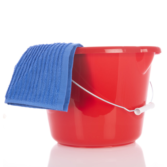 "Red plastic bucket with blue cloth" stock image