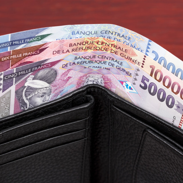 "Guinean franc in the black wallet" stock image