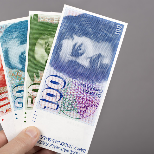 "Old Swiss franc in the hand on a gray background" stock image
