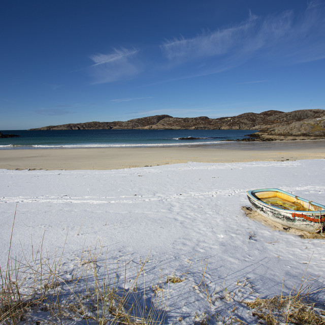 "Snow, Sunshine, a Boat and a Beach - Achmelvich, Scottish Highlands" stock image