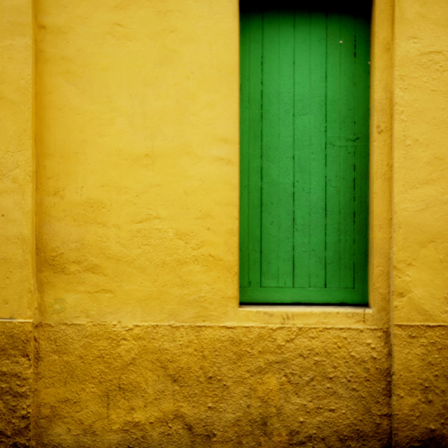 "a green door on a yellow wall" by Amit Mendelsohn - $49.42 "a green door on a yellow wall" stock image