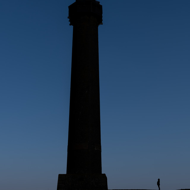 "Silhouette of person (Unrecognisable) looking up at the Wellington - Waterloo Monument Tower in the Scottish borders, Jedburgh, Scotland" stock image