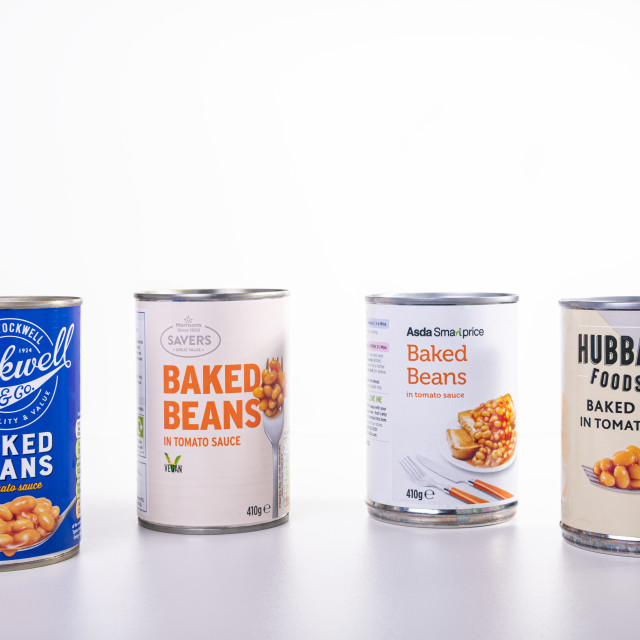 "Low Prices Baked Beans brands from Tesco, Morrisons, Sainsburys and Asda on a white background" stock image