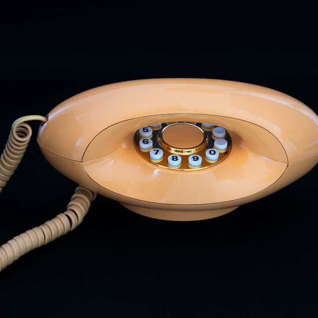 "Peach coloured 1970's Modern telephone handset" stock image