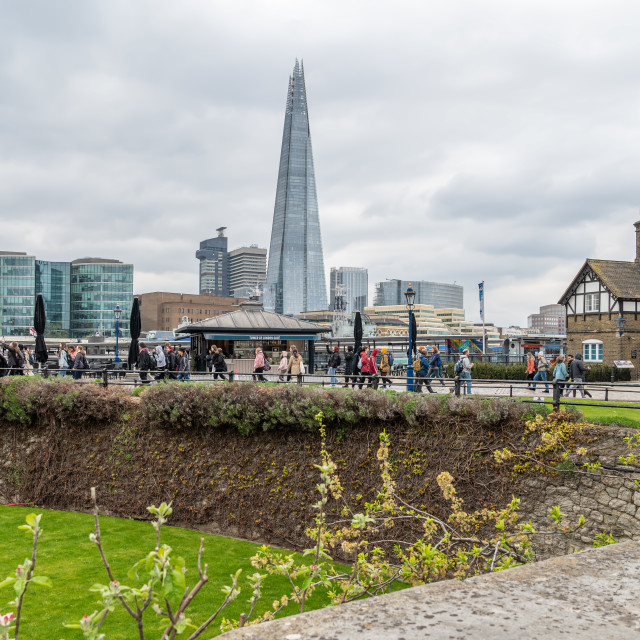 "The Shard Tower with a tourists on the North banks of the Thames in the foreground., London, England" stock image