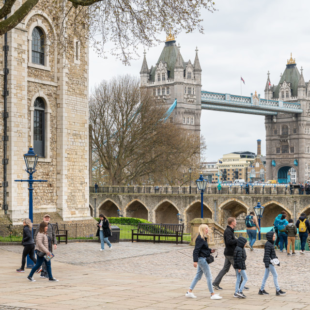 "Tower Bridge seen over the outer wall of The Tower of London, London, England" stock image