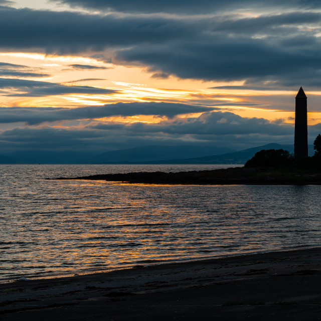 "Silhouette of the Battle of Largs Pencil Monument at sunset, Largs, Scotland" stock image