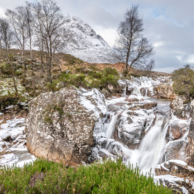 "Partly frozen Waterfall on the River Coupall with Buachaille Etive Mor and Stob Deargin the background, Glen Coe, Highlands, Scotland" stock image