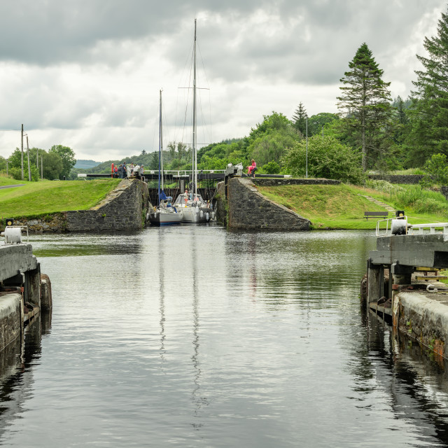 "Boats leaving lock 9 as seen from lock 10 on the Crinan Canal, Argyll and Bute, Scotland" stock image