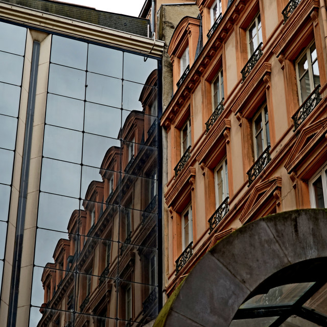 "a reflection of a building on it's own facade" stock image