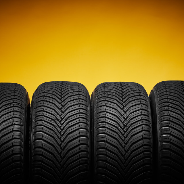 "Car tires, winter wheels isolated on yellow background and screwdriver" stock image