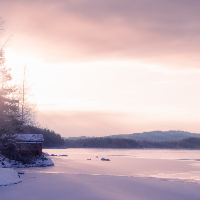 "Winter dawn over a frozen lake in Sweden" stock image