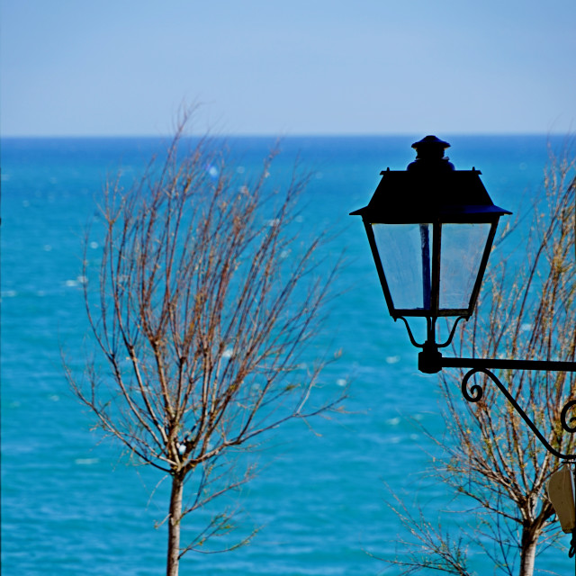 "A lamp a tree and the sea" stock image