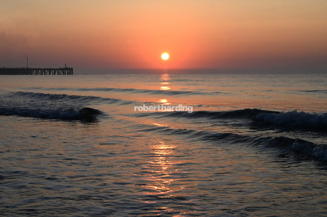 "Sunrise over calm sea silhouetting the old derelict harbour wall and groyne,..." by robertharding - $62.60 "Sunrise over calm sea silhouetting the old derelict harbour wall and groyne,..." stock image
