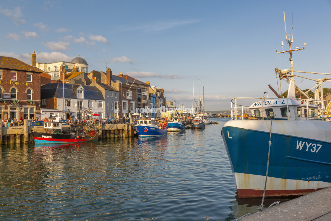 "View of boats in the Old Harbour and quayside houses at sunset, Weymouth,..." by robertharding - $62.60 "View of boats in the Old Harbour and quayside houses at sunset, Weymouth,..." stock image