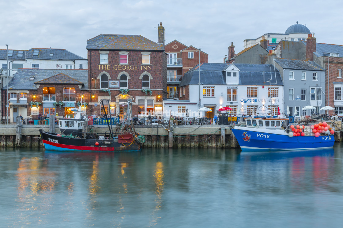 "View of boats in the Old Harbour and quayside houses at dusk, Weymouth,..." by robertharding - $62.60 "View of boats in the Old Harbour and quayside houses at dusk, Weymouth,..." stock image