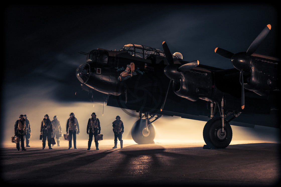 "Lancaster bomber and crew at night" stock image