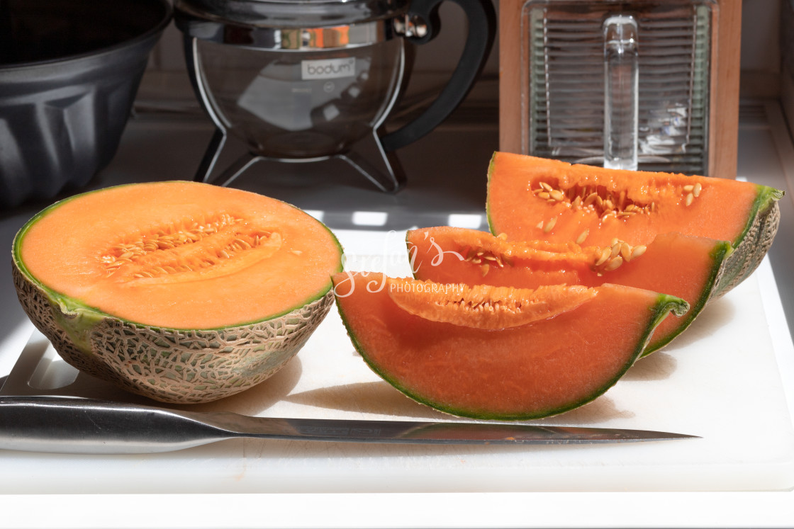 "Melon sliced on a white cutting board" by Stefan Schweihofer - £10.00 "Melon sliced on a white cutting board" stock image