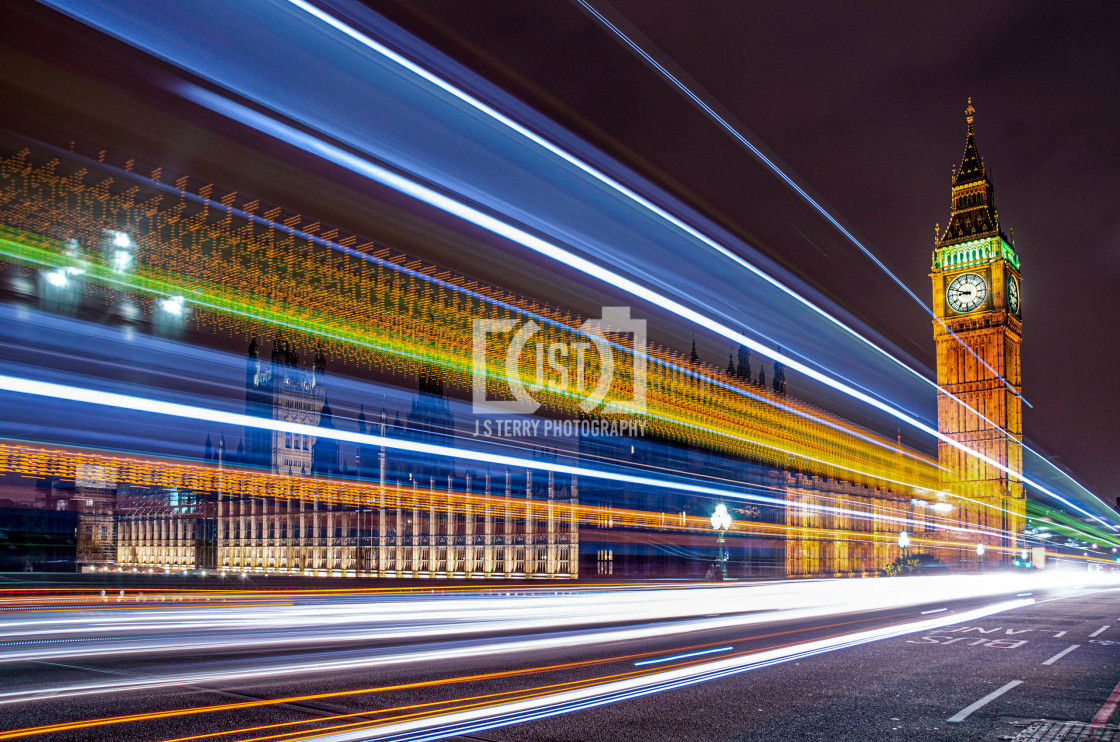 "A bus passing the Houses of Parliament and the Elizabeth Tower" stock image