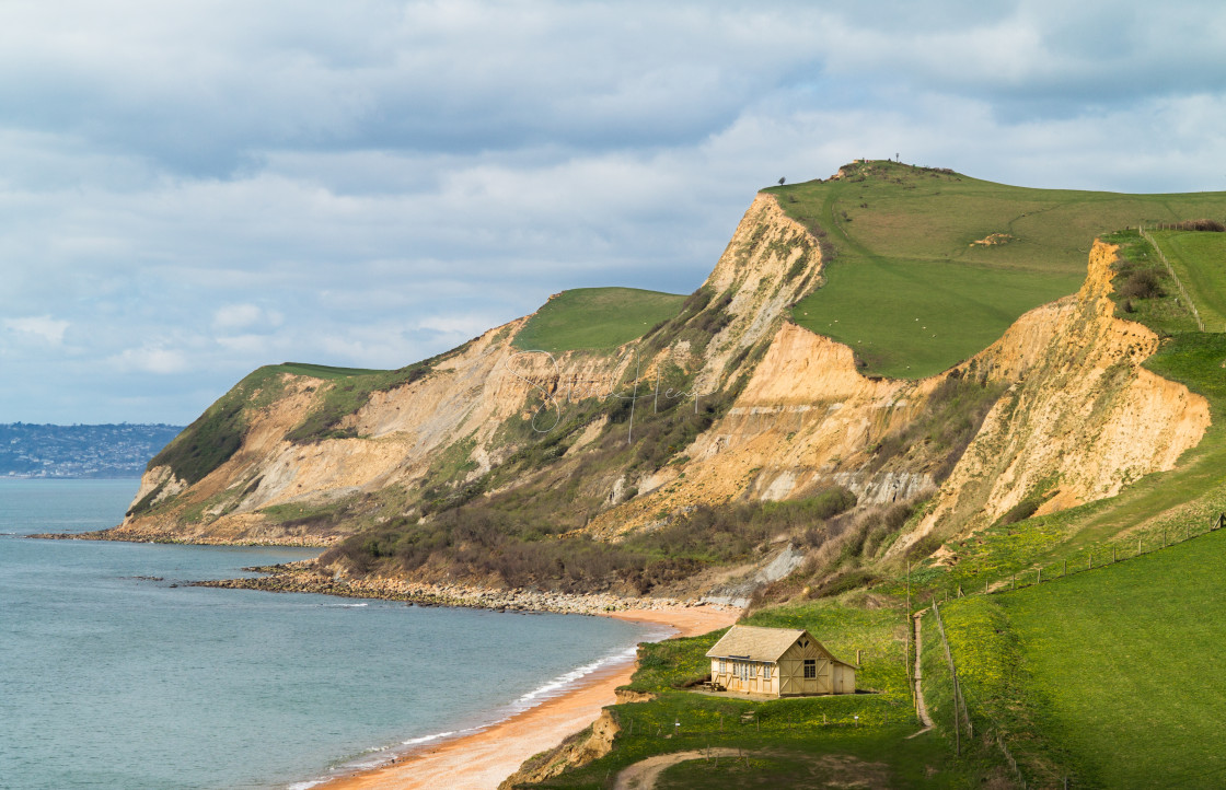 "Cottage by cliffs at West Bay Dorset in UK" stock image