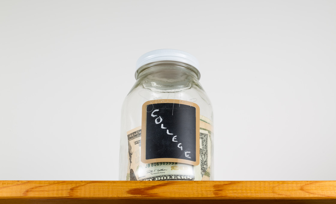 "Single glass jar on wooden shelf for saving money" stock image