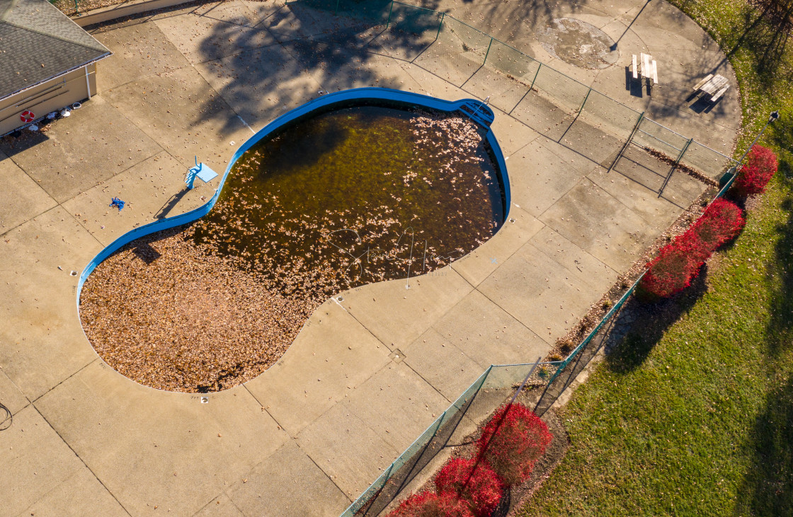 "Aerial drone photo of an uncovered swimming pool filled with fallen autumn..." stock image