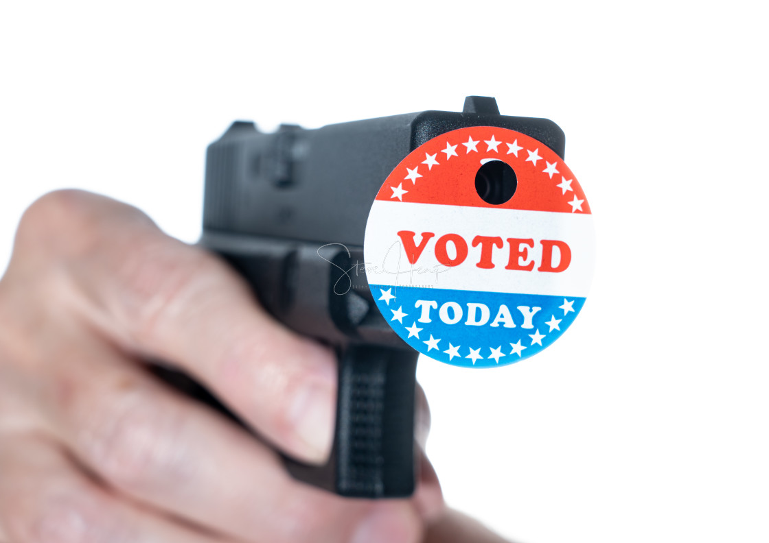 "I voted today campaign button with hole on handgun for voter suppression" stock image