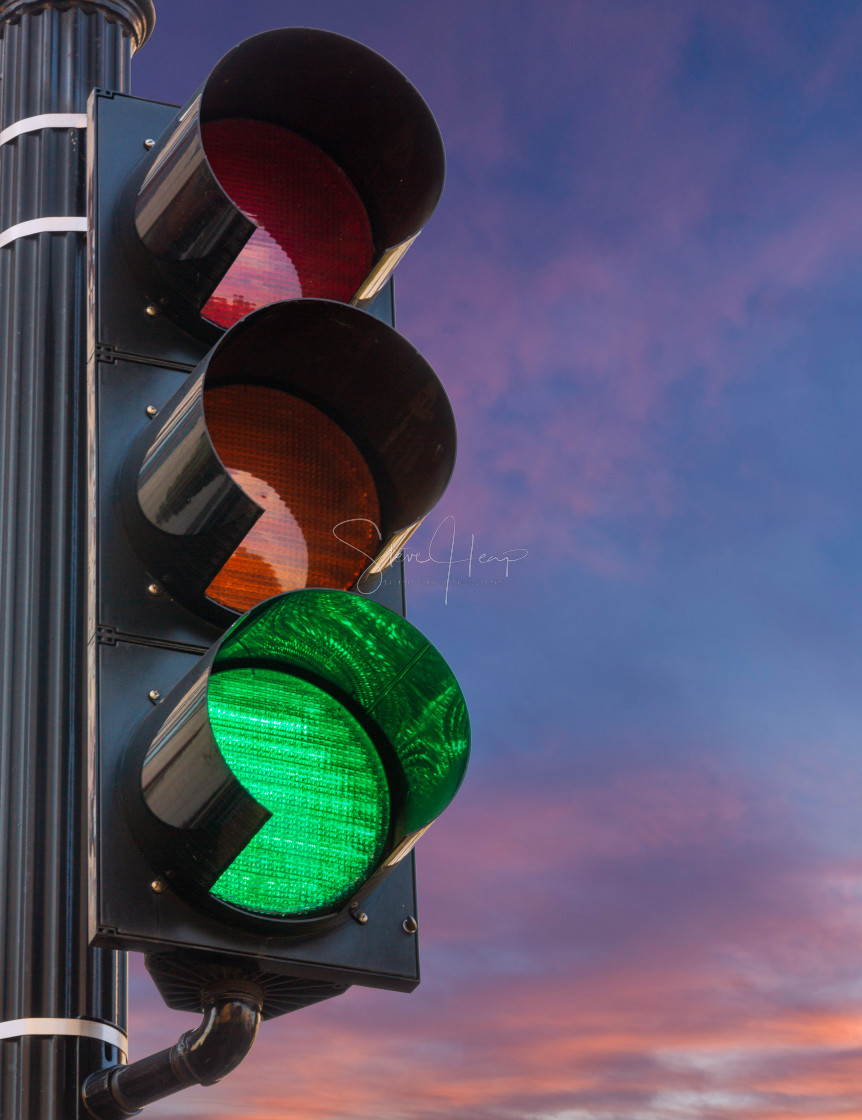 "Green light on traffic signal against sunrise as concept for hope" stock image