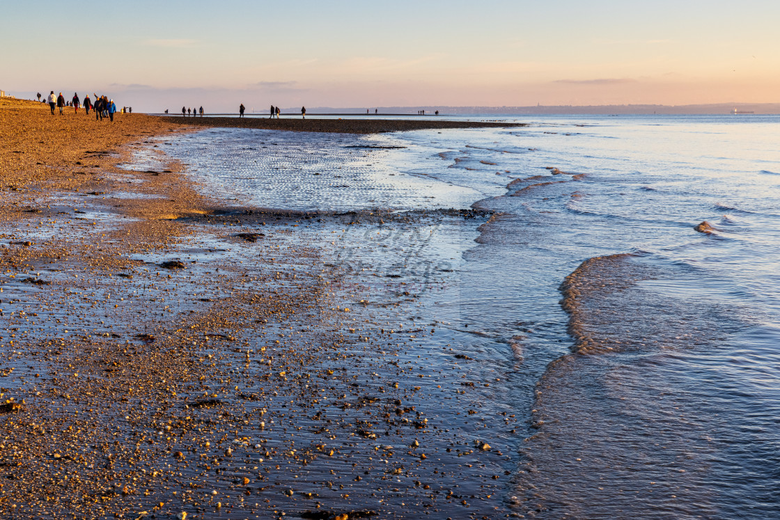 "Gentle waves from the receding tide lap the gravel beach at Meon" stock image