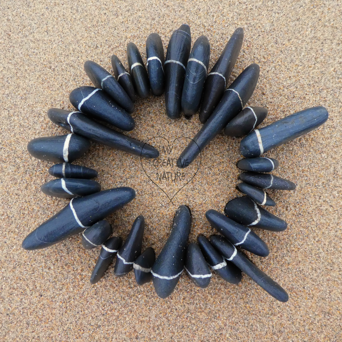 "circle of beach pebbles with lines" stock image