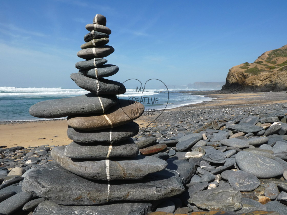 "beach stone balance along a line" stock image