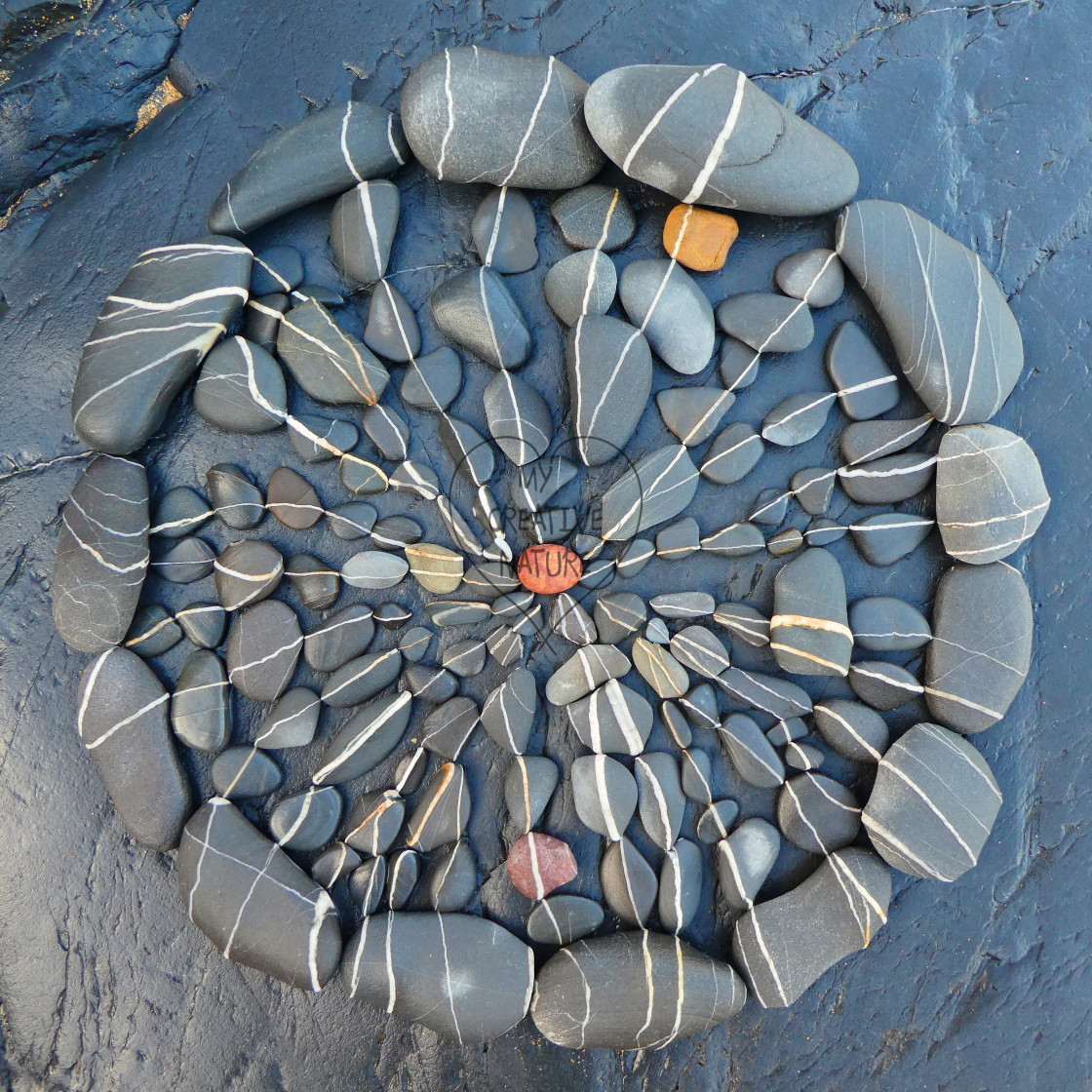 "circle mandala from beach pebbles" stock image