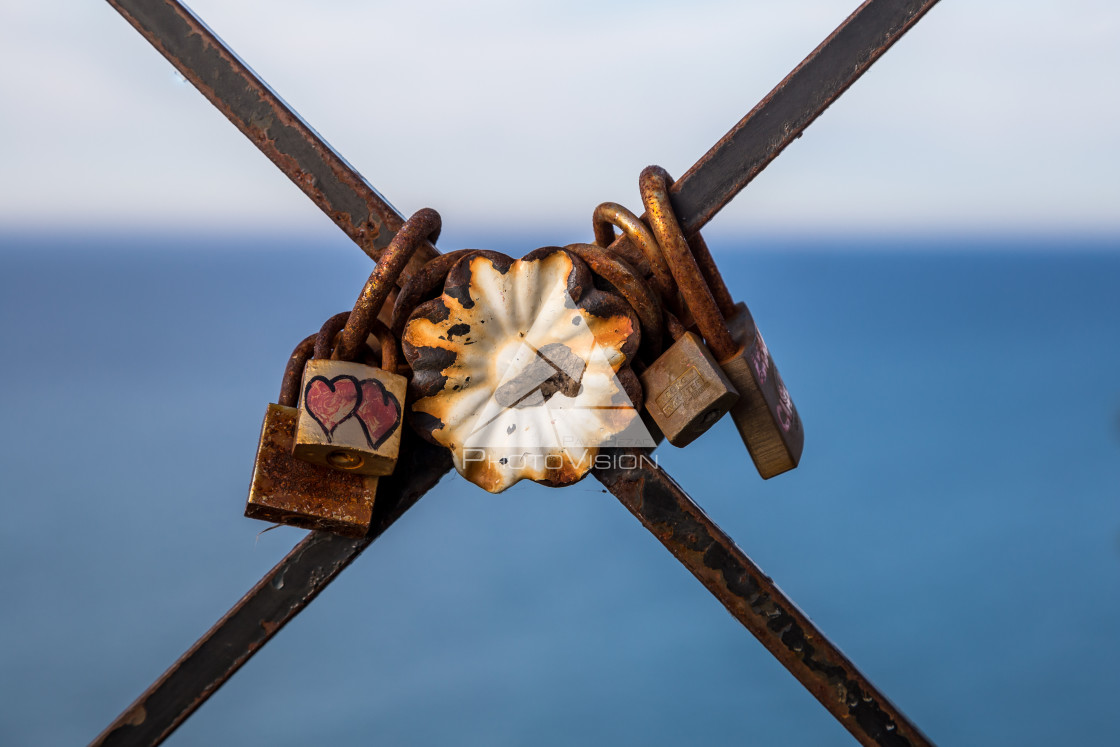 "Locks of love on a rusty fence" stock image