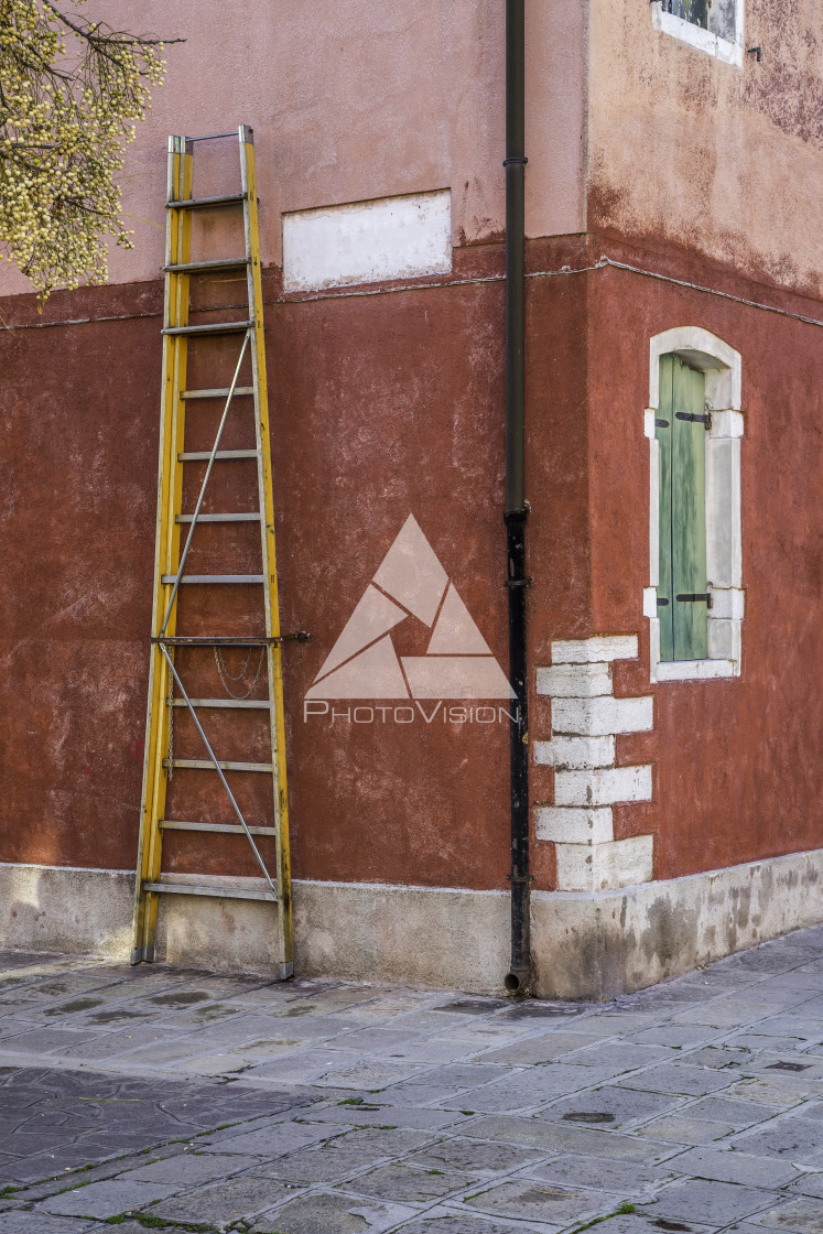 "Tall stepladder on red house, Murano island" stock image