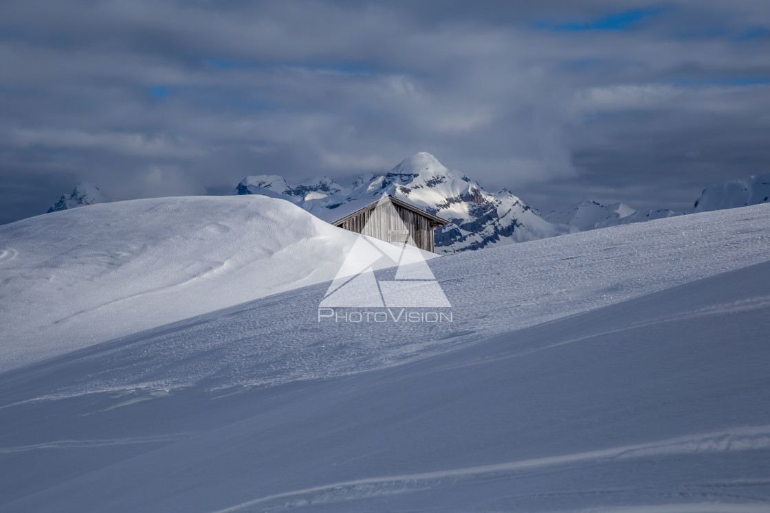 "Snow-covered wooden cottage in the Alps" stock image