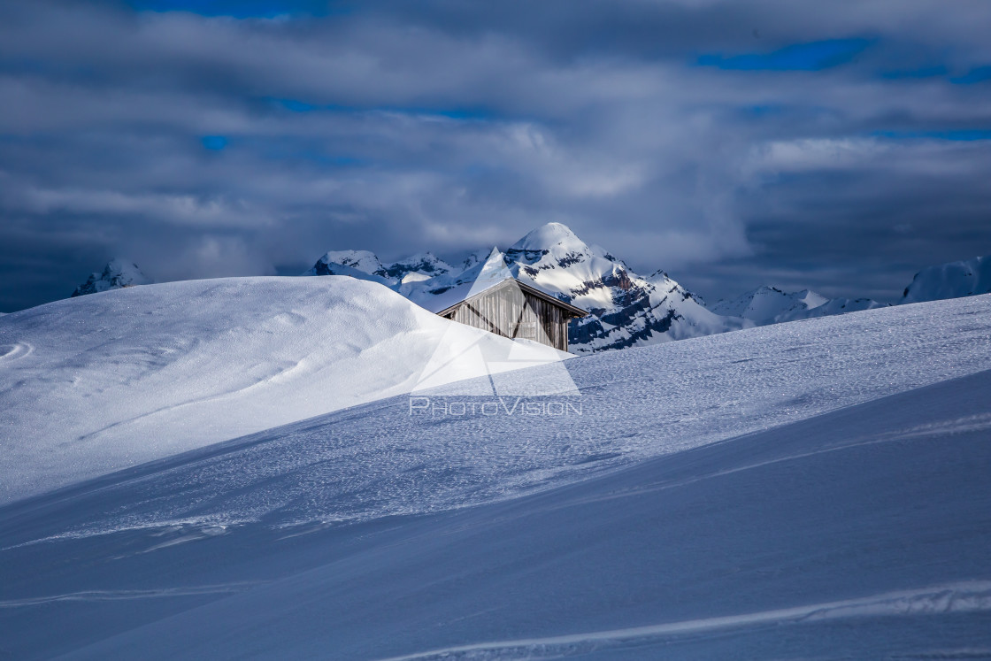 "Snow-covered wooden cottage in the Alps" stock image