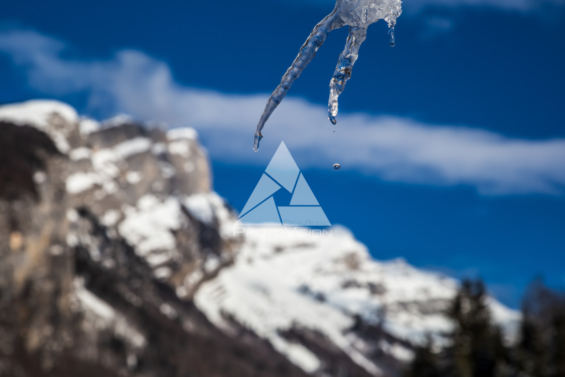 "detail of an icicle with a drop of water" stock image