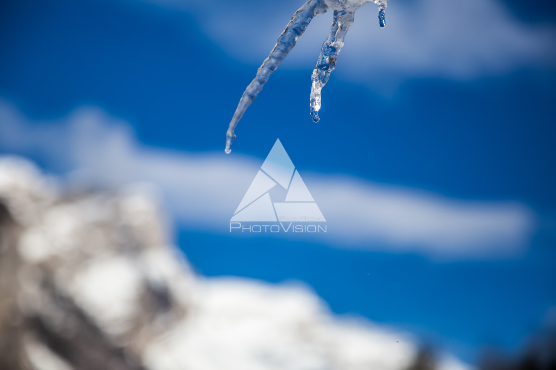 "detail of an icicle with a drop of water" stock image