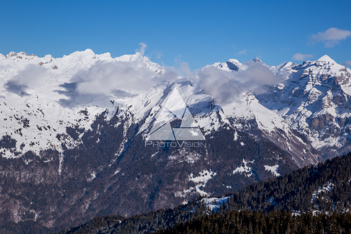 "Panorama of winter Alps with low clouds" stock image