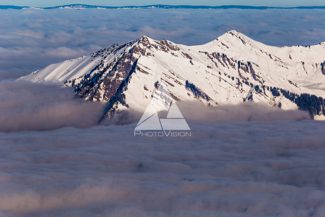 "Panorama of winter Alps with low clouds" stock image