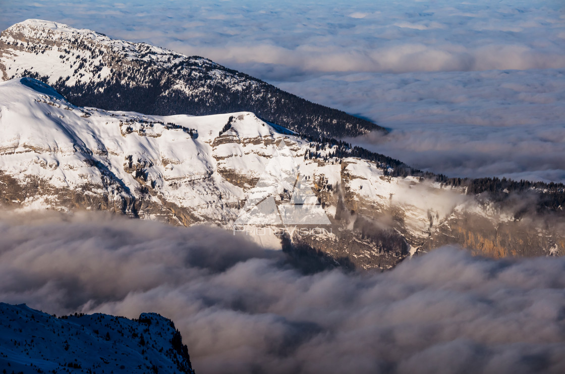 "Panorama of winter Alps with low clouds" stock image