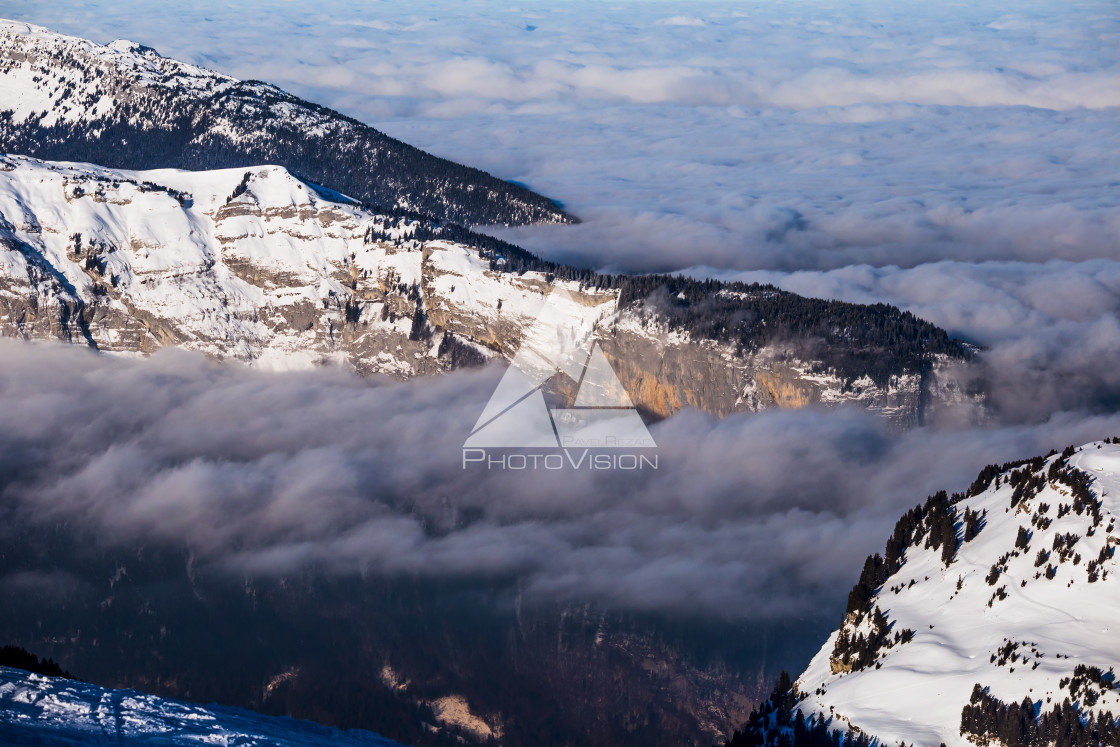 "Panorama of winter Alps with low clouds" stock image