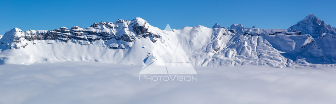 "Panorama of mountains rising from the clouds" stock image