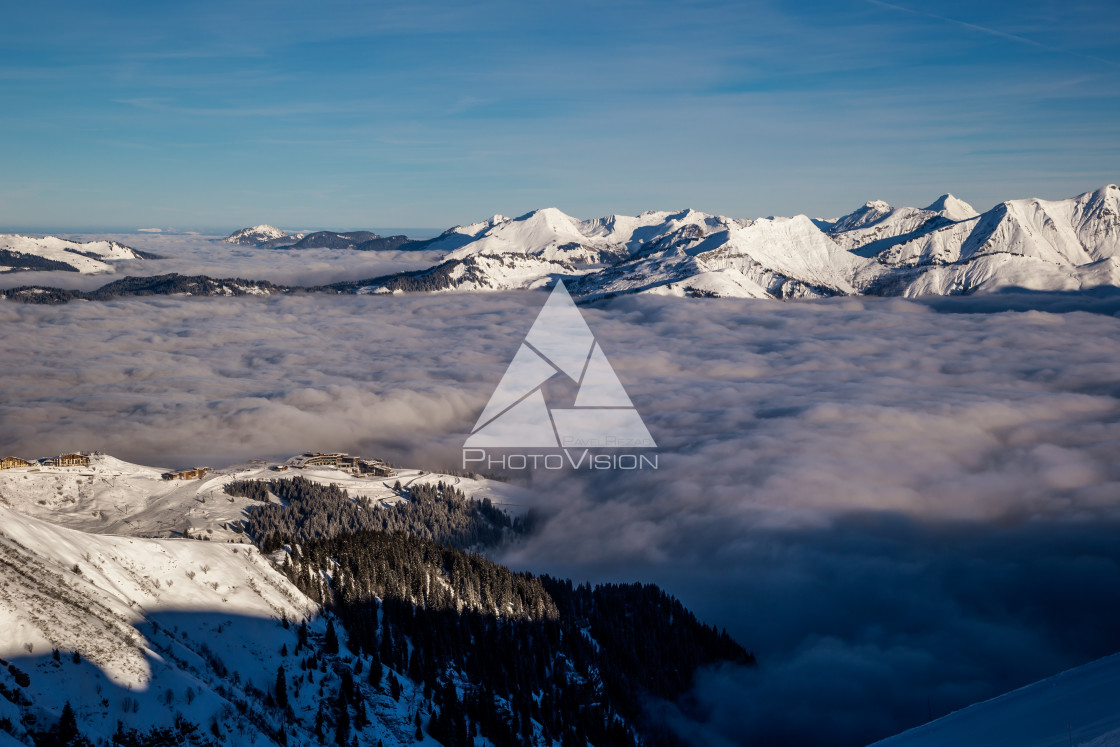 "Inversion in valley and illuminated mountain peaks" stock image