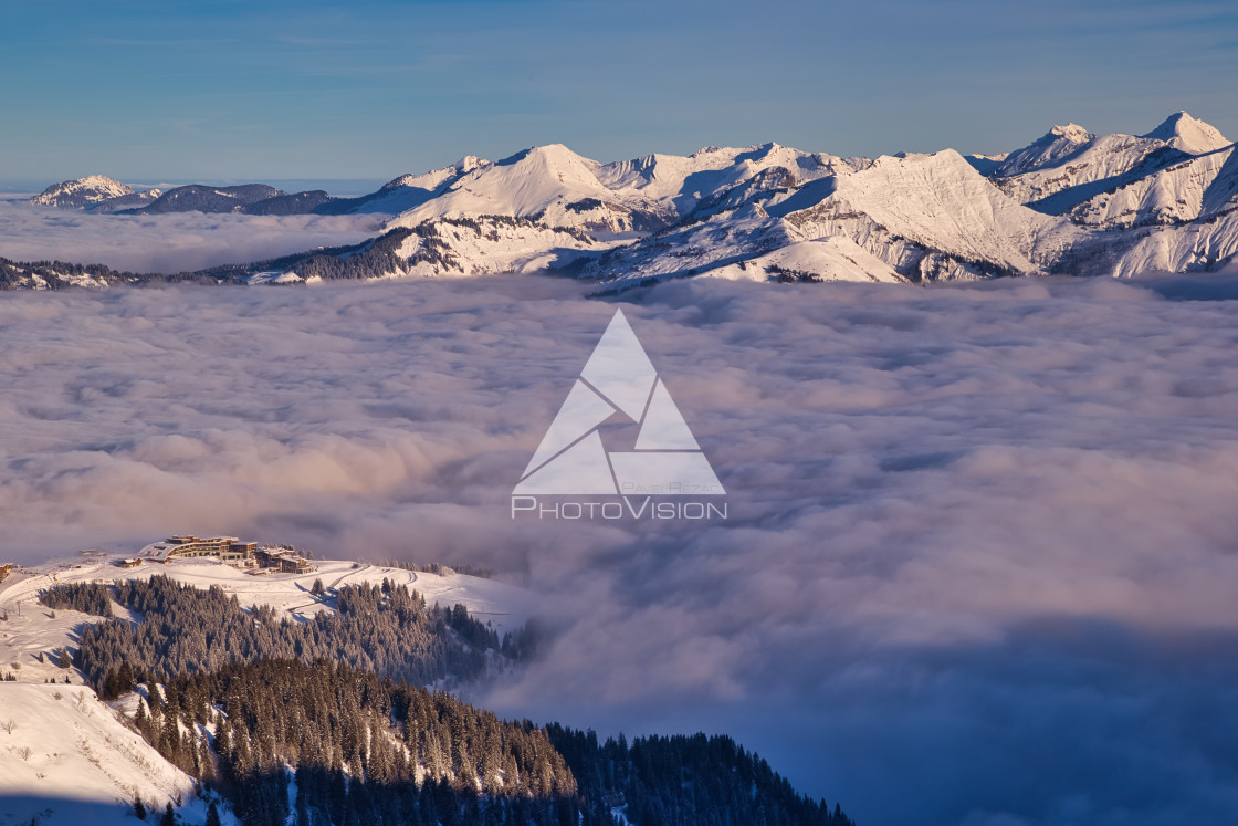 "Inversion in valley and illuminated mountain peaks" stock image