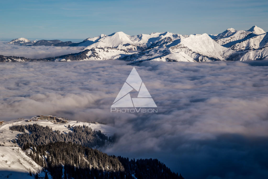 "Inversion in valley and illuminated mountain peaks" stock image